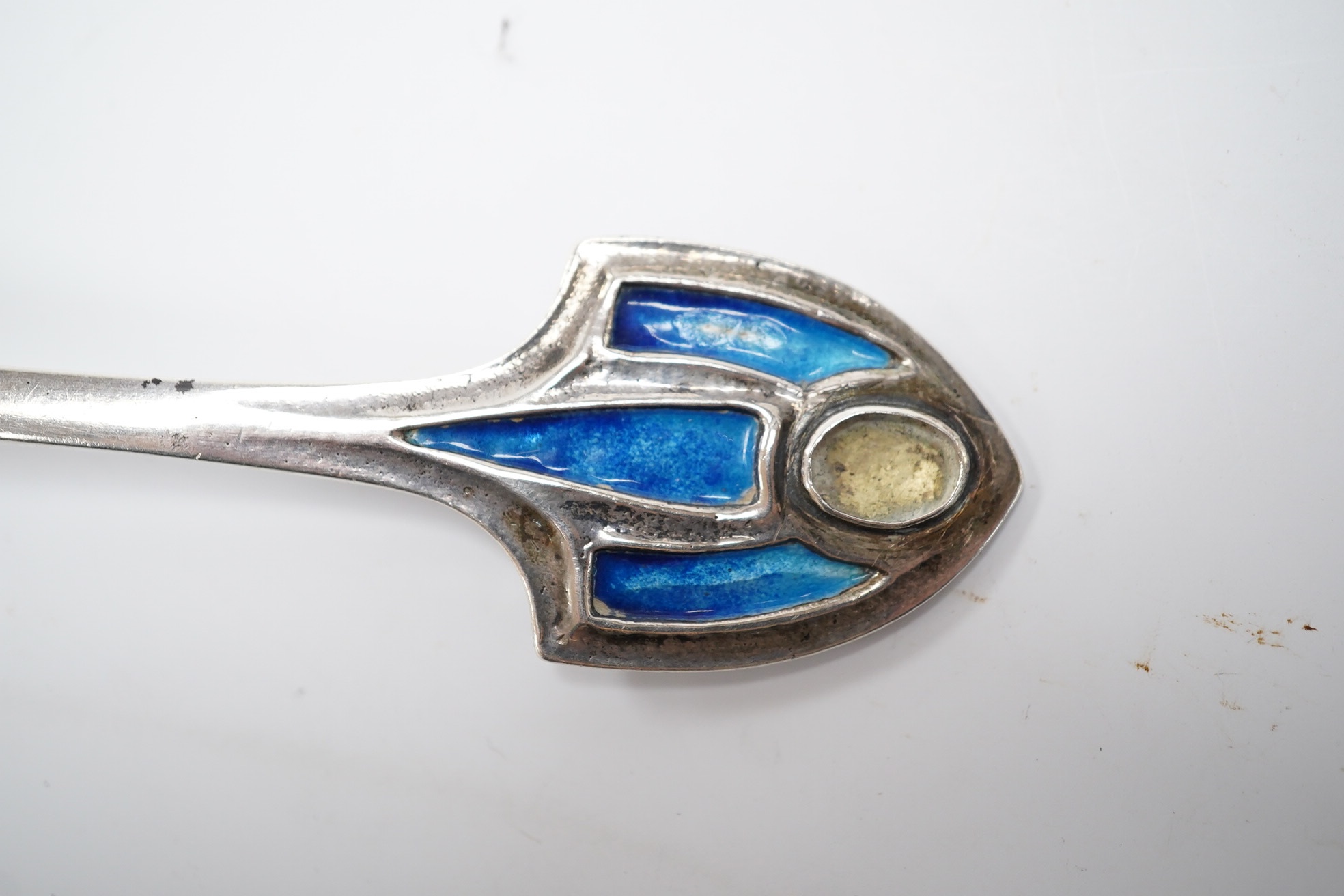 An Edwardian Art Nouveau Kate Harris for William Hutton & Sons silver and enamel spoon, the terminal lacking stone?, London, 1903, 18.4cm, gross weight 63 grams. Condition - poor